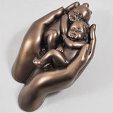 NEW BORN BABIES IN HAND, COLD CAST BRONZE SCULPTURE BY LOVE IS BLUE